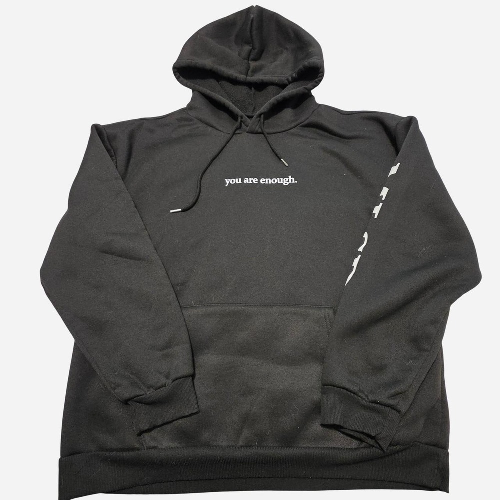 Black hoodie with white text reading 'you are enough.'